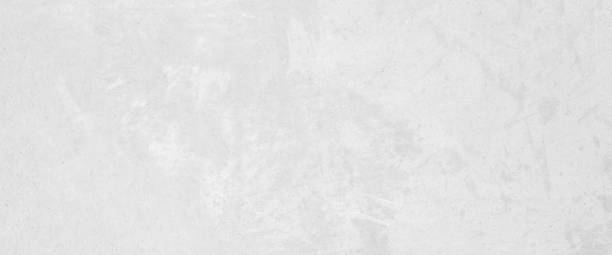 istock White concrete stone surface paint wall background, Grunge cement paint texture backdrop, White rough concrete stone wall background, Copy space for interior design background, banner, wallpaper 1901819992