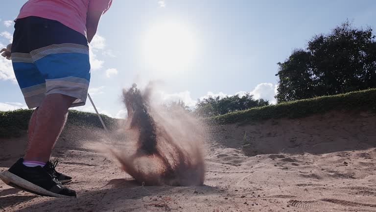 Pro golf player shot golf ball from sand bunker