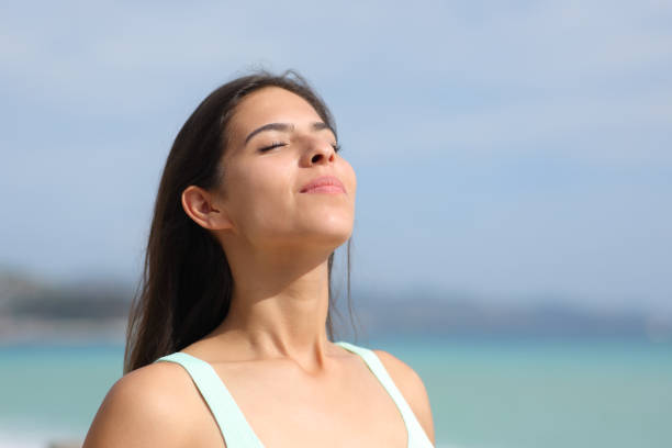 istock Satisfied woman breathing on the beach 1901838767
