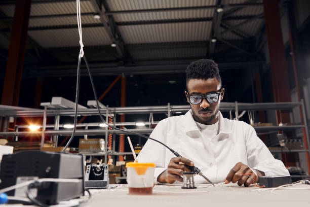 istock African engineer using soldering iron at factory 1901843497