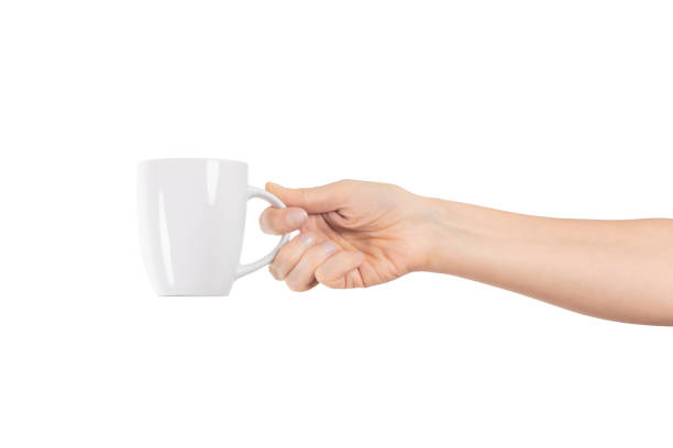 istock A woman's hand holds a white ceramic cup isolated on white background. Tea or coffee break. 1901863433