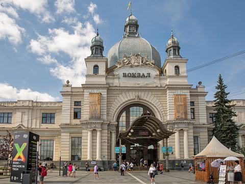 Lviv, Ukraine - September 08, 2023: People visit main railway station building. It is one of the most notable pieces of Art Nouveau architecture in former Galicia, it was opened to the public in 1904.