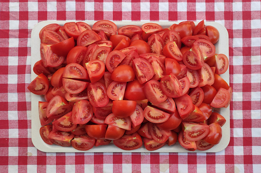 Chopped tomatoes pieces in a tray on the table