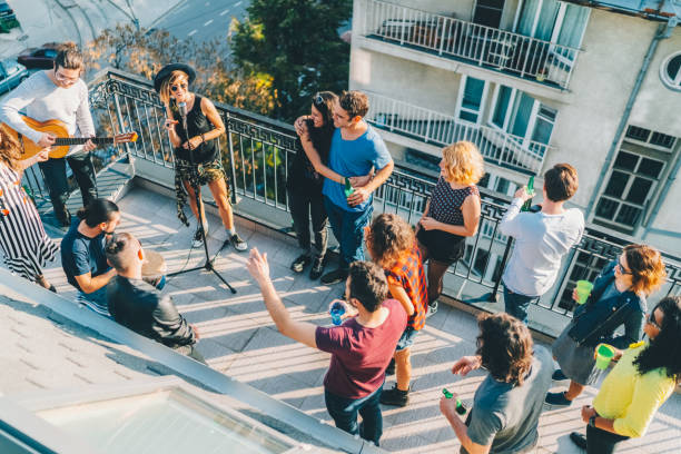 istock Friends drinking and partying on the rooftop 1901904770