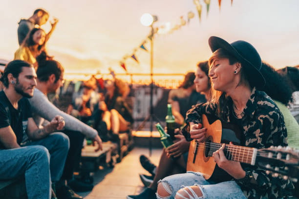 friends drinking and partying on the rooftop - individual event women people autumn imagens e fotografias de stock