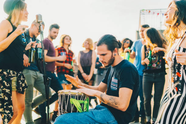 friends drinking and partying on the rooftop - individual event women people autumn imagens e fotografias de stock