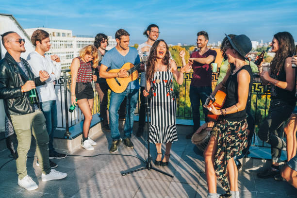 friends drinking and partying on the rooftop - individual event women people autumn imagens e fotografias de stock