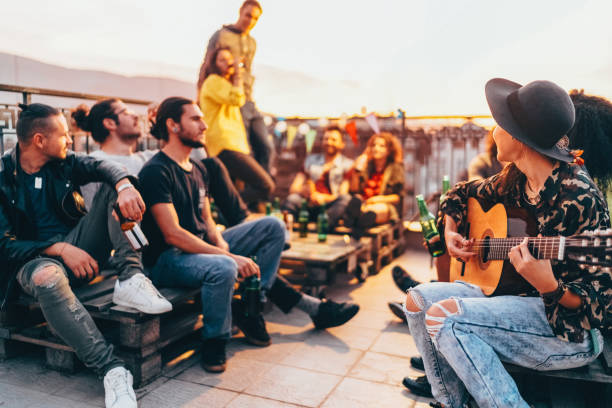 friends drinking and partying on the rooftop - individual event women people autumn imagens e fotografias de stock