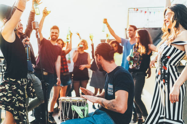 istock Friends drinking and partying on the rooftop 1901912128