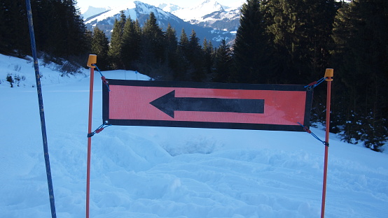 Ski direction sign on a ski slope in the French Alps, France