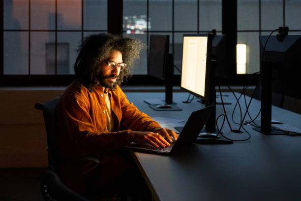 istock Focused businessman working late in dark office 1901943065