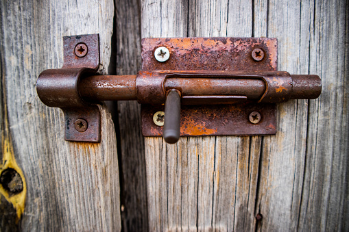 detail of old latch on wooden gate