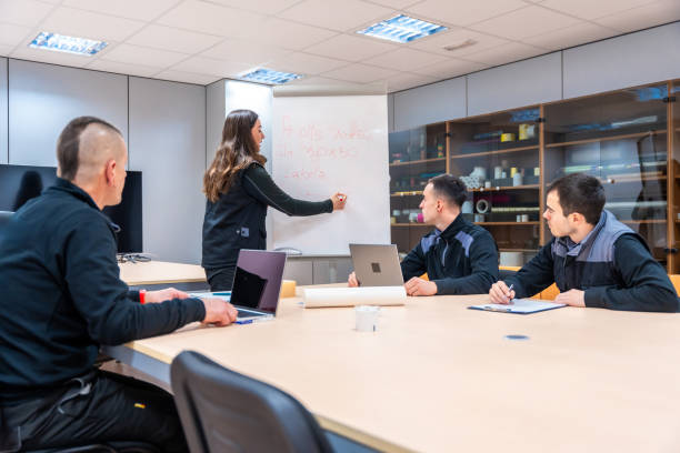 istock Woman using a board during a brainstorm meeting with engineers 1901958483