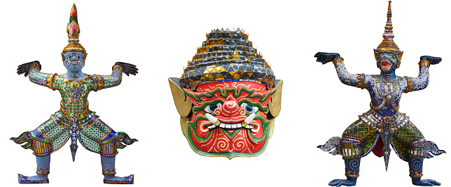 close up of demon mask and demon stutue in ramayana saga which support golden pagoda isolated on white background.
