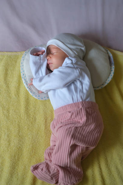 istock Peaceful baby lying on a bed while sleeping in a bright room. 1901967814