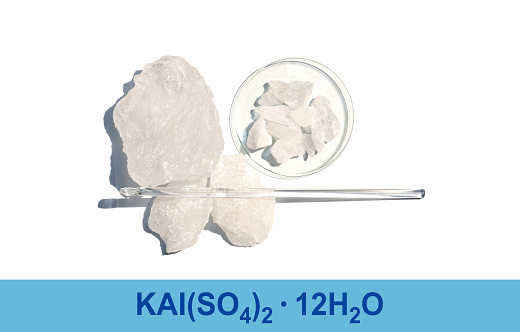 Alum Crystal with chemical formula, chemical ingredient on white laboratory table.