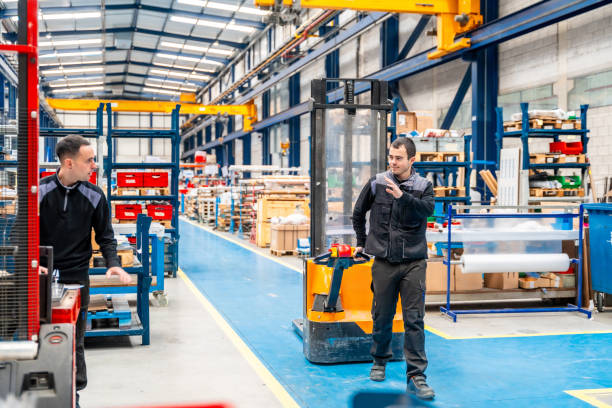 istock Coworkers using handcart in a logistic center 1901979662