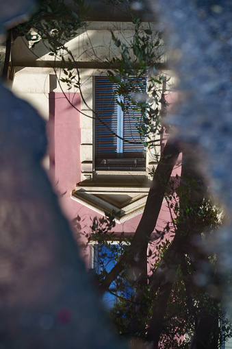 Milan, Lombardy, Italy: house reflected in a puddle along via Biondi