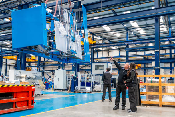 istock Team of engineers lifting heavy machinery using a crane 1901999689