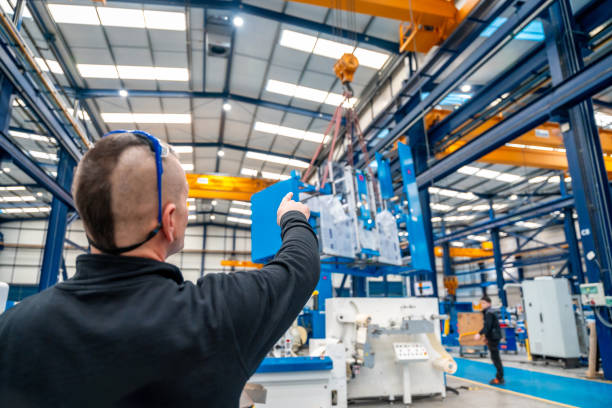 istock Worker directing the maneuvers of an industrial crane 1902003720
