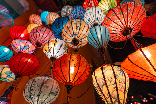 Vibrant sights: Colored silk lanterns illuminate the ancient streets of Hoi An, Vietnam, adding a mesmerizing glow to its historic charm
