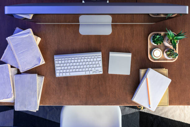 istock Student desk with computer, books and notepads on a wooden table. 1902064738