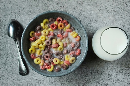 a bowl of cereal and a glass of milk on the table