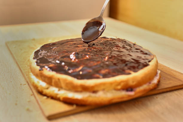 istock Chocolate cake decoration. Cooking a festive pie at home 1902068456
