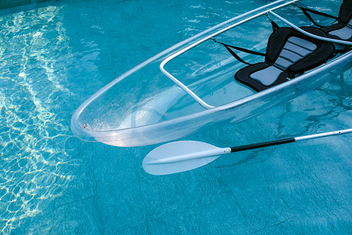 Carbon fiber PC transparent boat on the swimming pool.