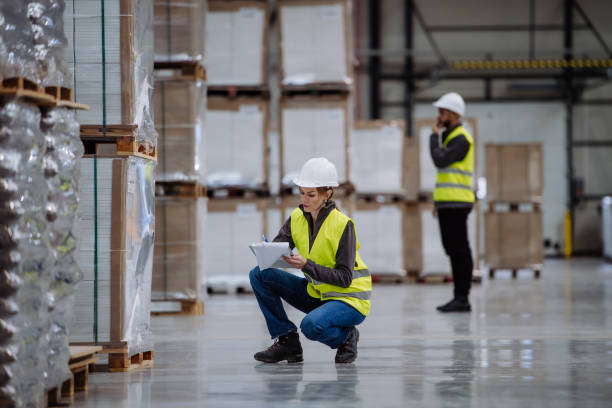 istock Female warehouse worker reading product order, order picking. Warehouse manager checking delivery, stock in warehouse, inspecting products for shipment. 1902092861