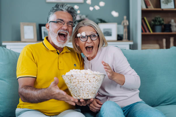 istock Mature couple watching TV at home. 1902114142