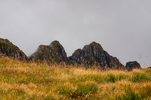 A view of the Aonach Eagach from the south side. Showing the rugged profile of the ridge with a grassy forground.
