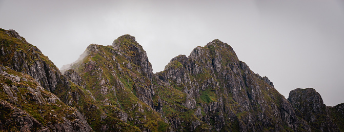 A fork in the footpath ahead of a steep pinnacle on the Scottish mountain of Beinn Alligin, one of the most prominant of the Torridon Mountains in the north west of Scotland.  The pinnacles along the ridge are also known as the Horns of Alligin.