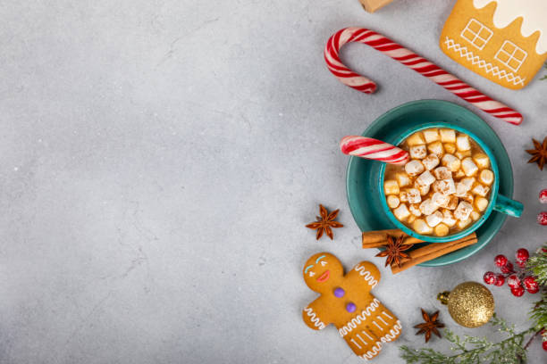 istock Hot drink with marshmallows and candy cane in cup on a texture table.Cozy seasonal holidays.Hot cocoa with gingerbread Christmas cookies.Hot chocolate with marshmallow and spices.Copy space. 1902136732