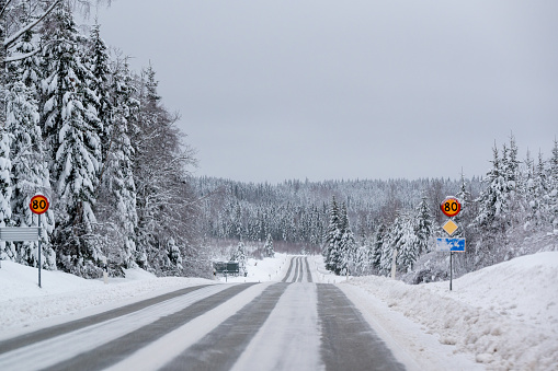 Signs with speed limit 80 kilometer per hour a cold winters day in Sweden January 1 2024