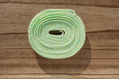 top view green plastic clothesline on a wood table