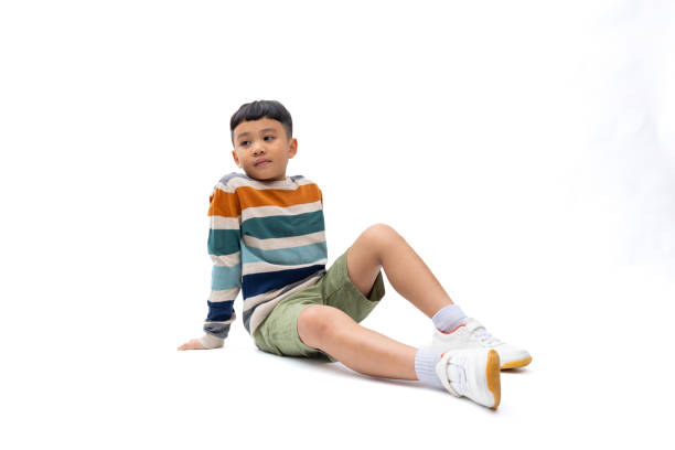 istock Multi-colored long-sleeved shirt. Portrait Young Asian cute boy posing on white background banner. 1902159830