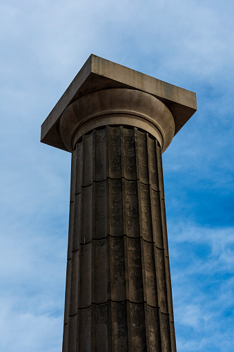 A single Column (seems Doric style to me) on the Spain park, cropped against the sky. In Rosario city, Santa Fe province, Argentina. On day October 17, 2023.