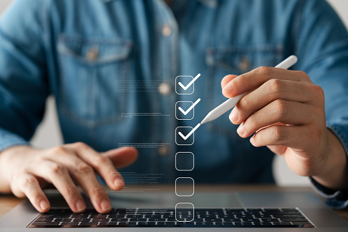 Business performance monitoring concept, businessman using laptop Online survey filling out, digital form checklist, blue background.