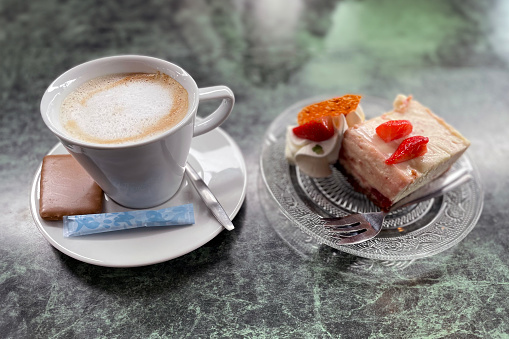 Cappuccino cup with cake
