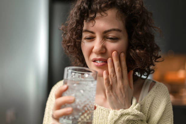 istock Young woman having toothache at home 1902200133