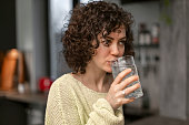 Mature adult woman drinking water from a glass