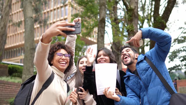 Young university students taking a selfie outdoors
