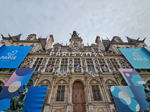 Paris, France - January 1, 2024: Facade of the Paris City Hall (l'Hôtel-de-Ville) announcing the Paris 2024 Olympic Games