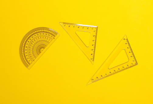 Set of rulers on a yellow background. Back to school, geometry, exact sciences