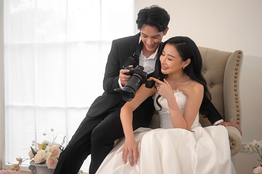 Groom taking pictures of beautiful bride for wedding ceremony, Love ,Romantic and wedding proposal concept.