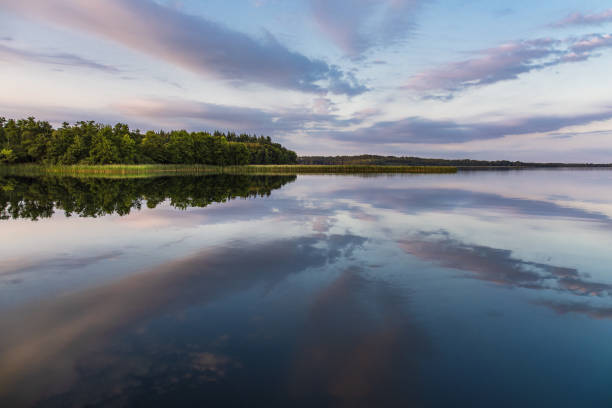 istock Reflection at the lake Schaalsee during sunrise in Seedorf, Germany 1902275408