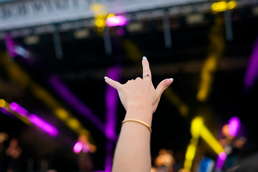 Close Up Of Person Making Rock And Roll Hand Gesture At Outdoor Summer Music Festival