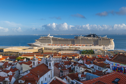 Lisbon, Portugal - October 15, 2023- MSC Preziosa cruise ship at Jardim do Tabaco Quay cruise port in the capital city, cityscape of Alfama district.