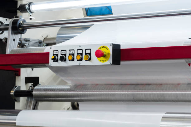 istock Automatic polyethylene plastic bag production machine with lighting effect. Close-up of the roller of the plastic bag production machine in the light blue scene. product packaging concept 1902292410